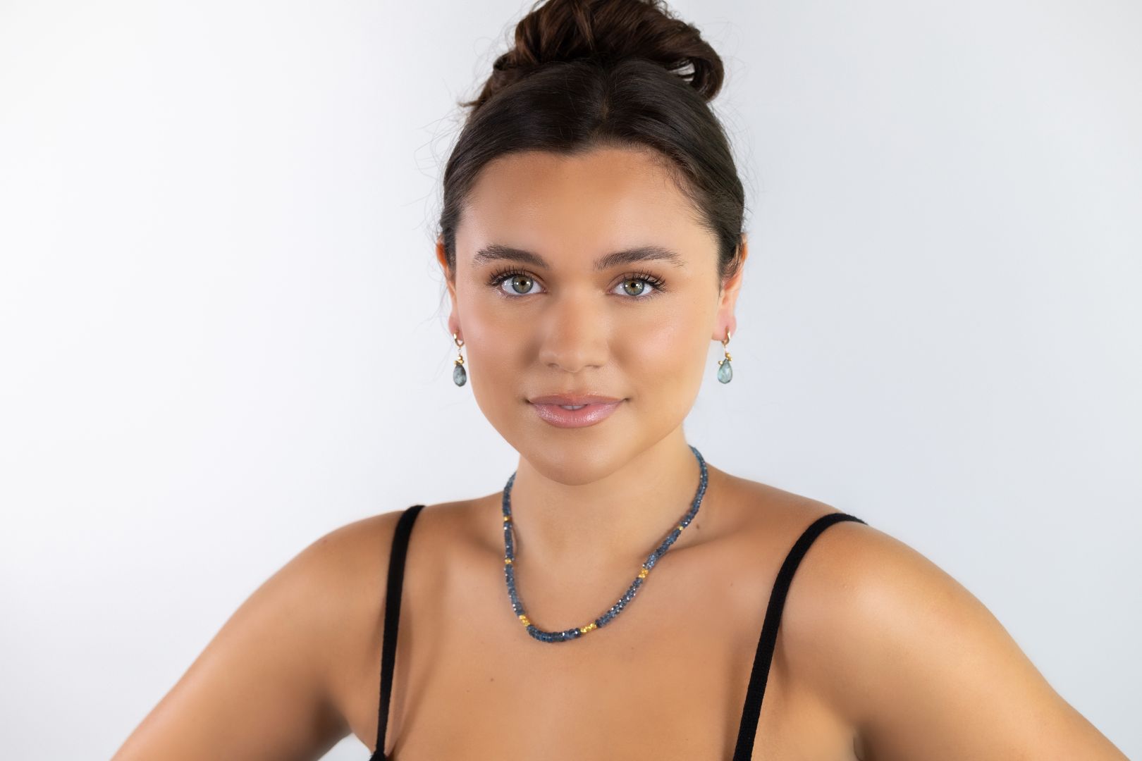 model wearing necklace and earrings